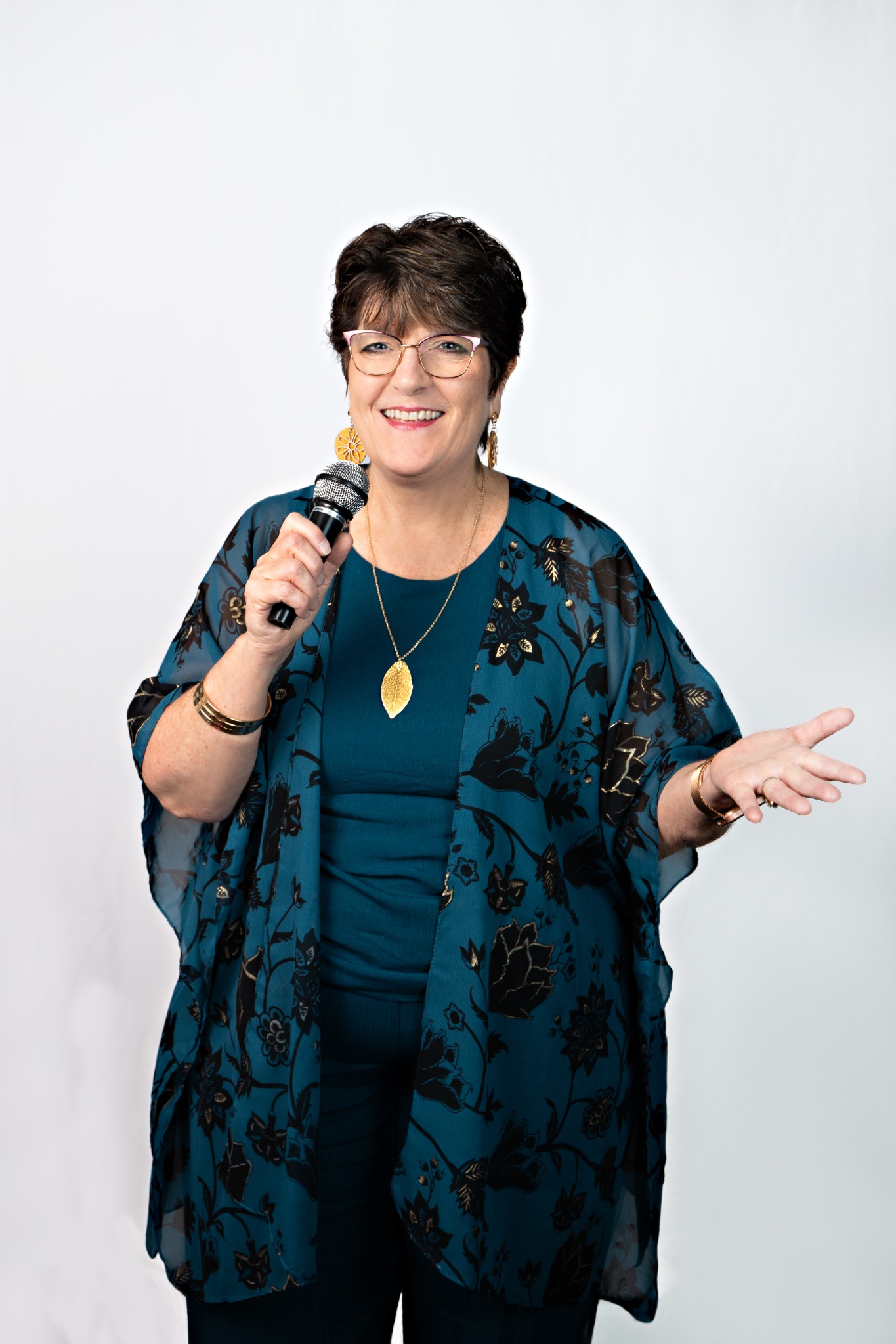 Cyndi Thomsen, theatre director and audition coach, holding a microphone